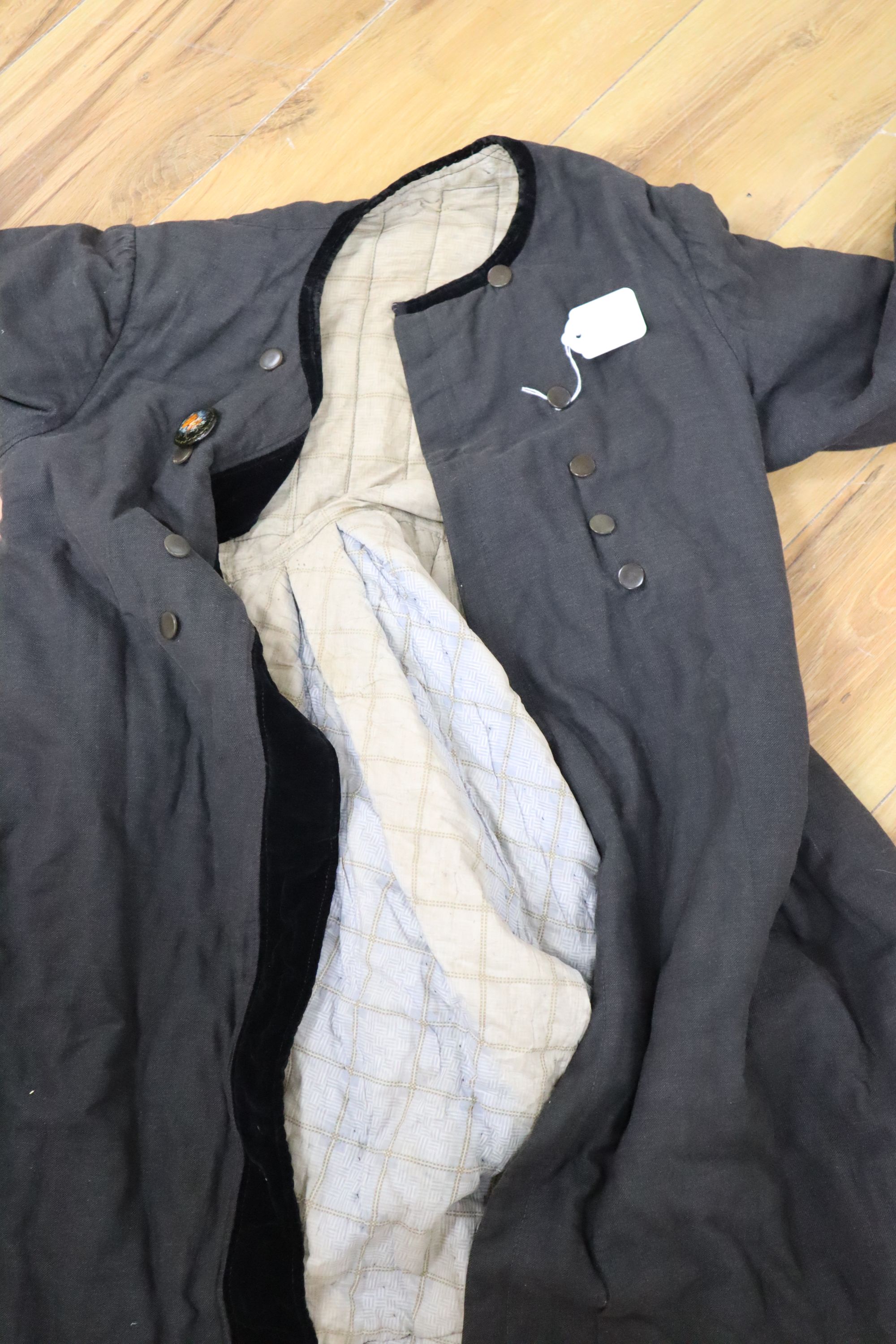 A 19th century Russian linen velvet edged coat with padded lining